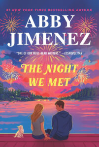 The cover of The Night We Met by Abby Jimenez featuring two people sitting on a bridge and  a small dog